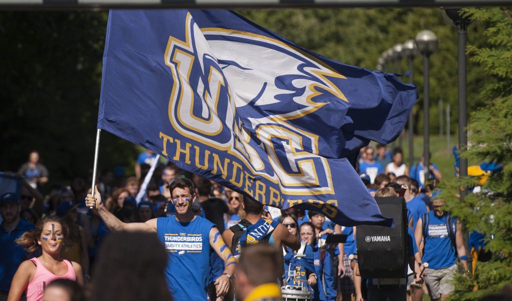 Chris Howe waving the flag on the first Great Thunderbird Trek to Homecoming