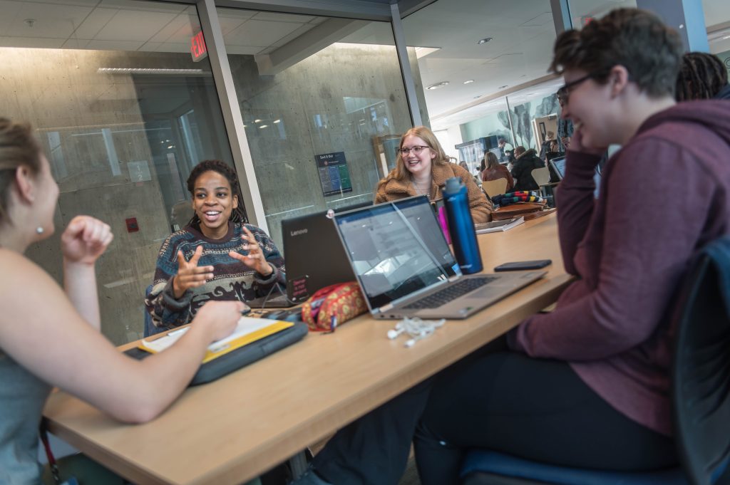 A group of UBC students having a discussion in a study room.