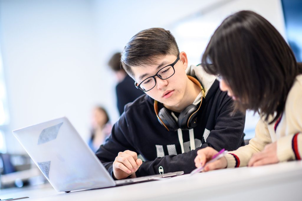 Two students working together in class.